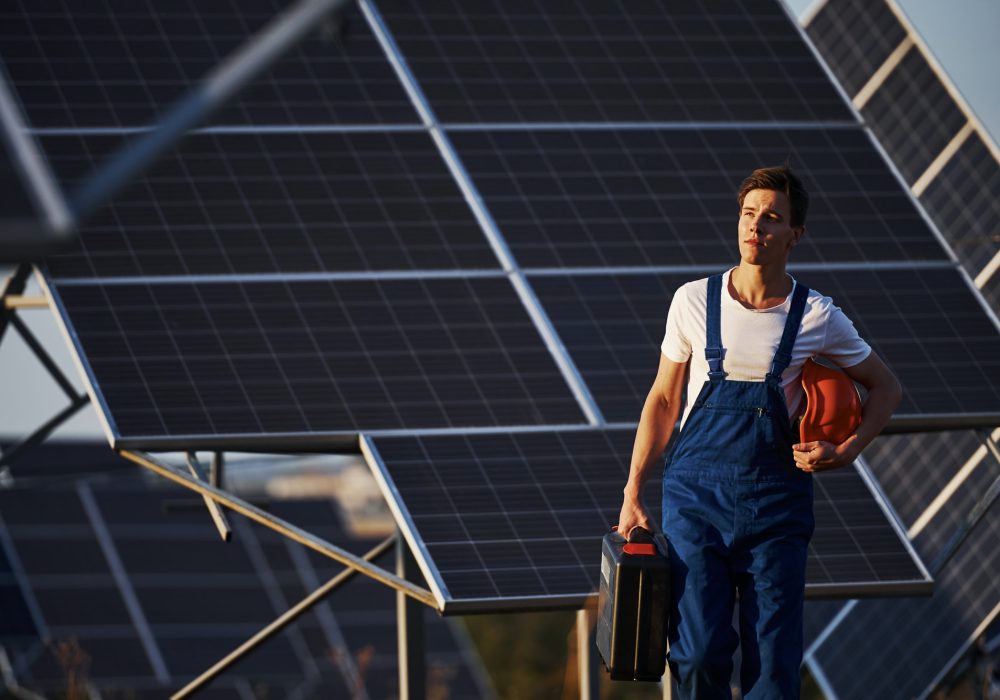 male-worker-in-blue-uniform-outdoors-with-solar-batteries-at-sunny-day.jpg