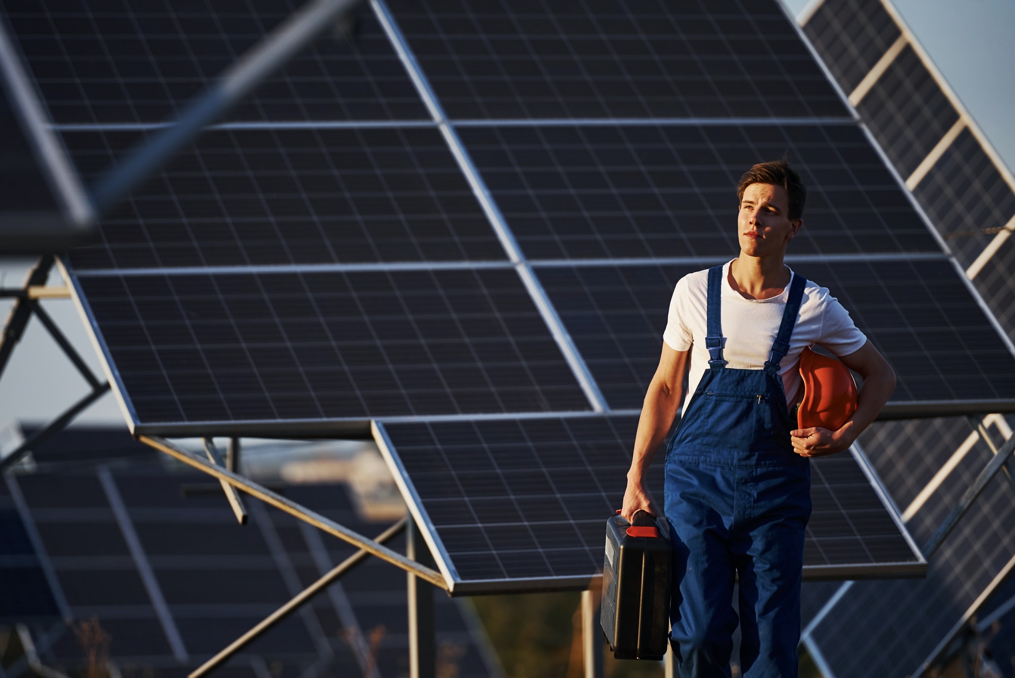male-worker-in-blue-uniform-outdoors-with-solar-batteries-at-sunny-day.jpg male-worker-in-blue-uniform-outdoors-with-solar-batteries-at-sunny-day.jpg